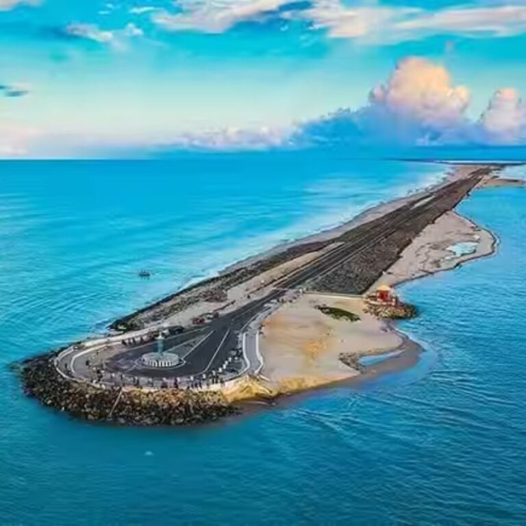 A bird's-eye view shows the Dhanushkodi Beach road stretching into the sea at the very end of Rameswaram, Tamil Nadu.