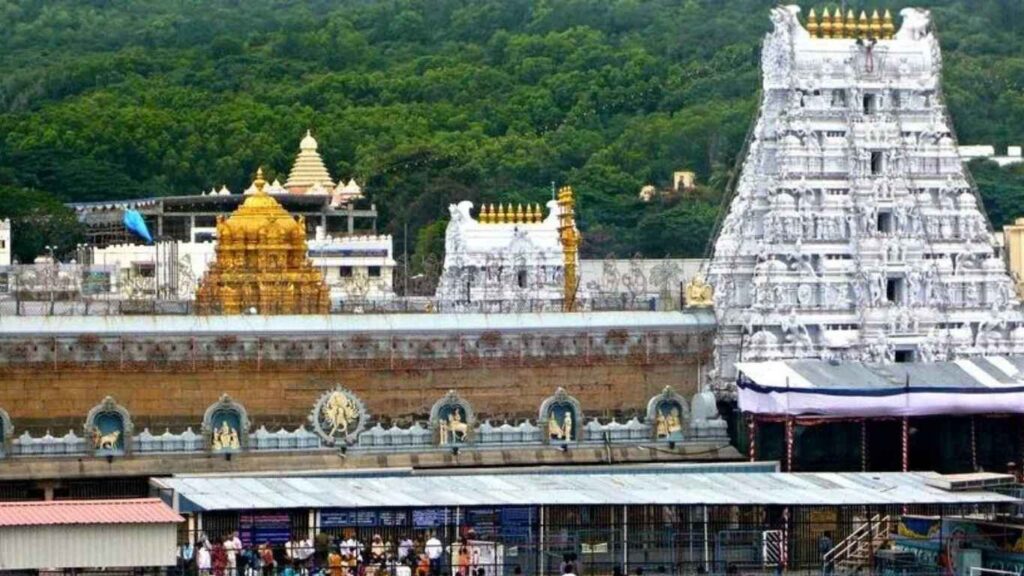 Tirupati Venkateswara Temple with golden and white gopurams, nestled in lush green Tirumala hills.