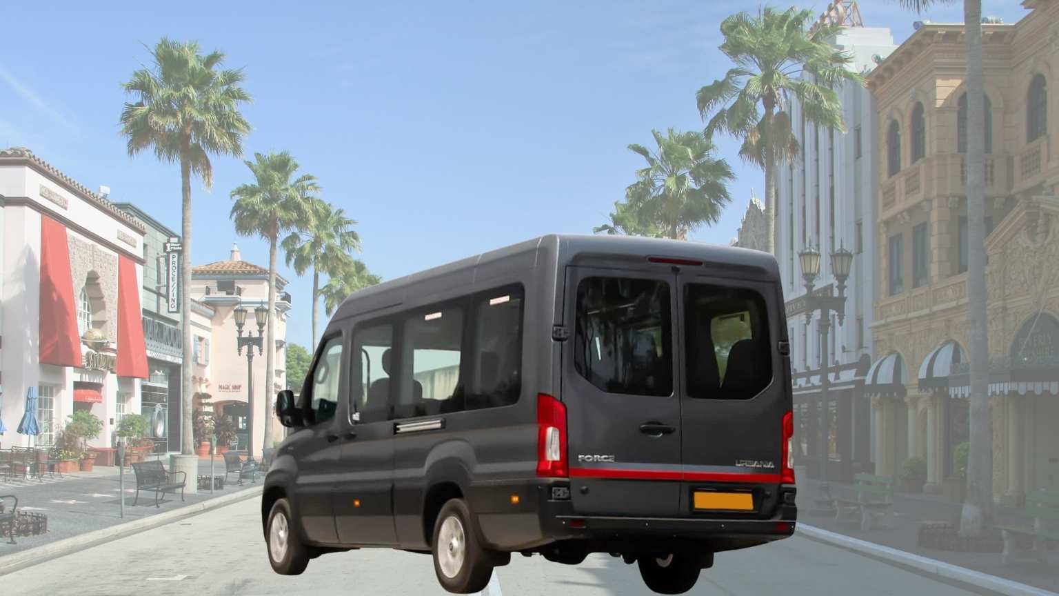 A Force Urbania luxury van is seen from the back on a city street, perfect for group cab bookings in Madurai.