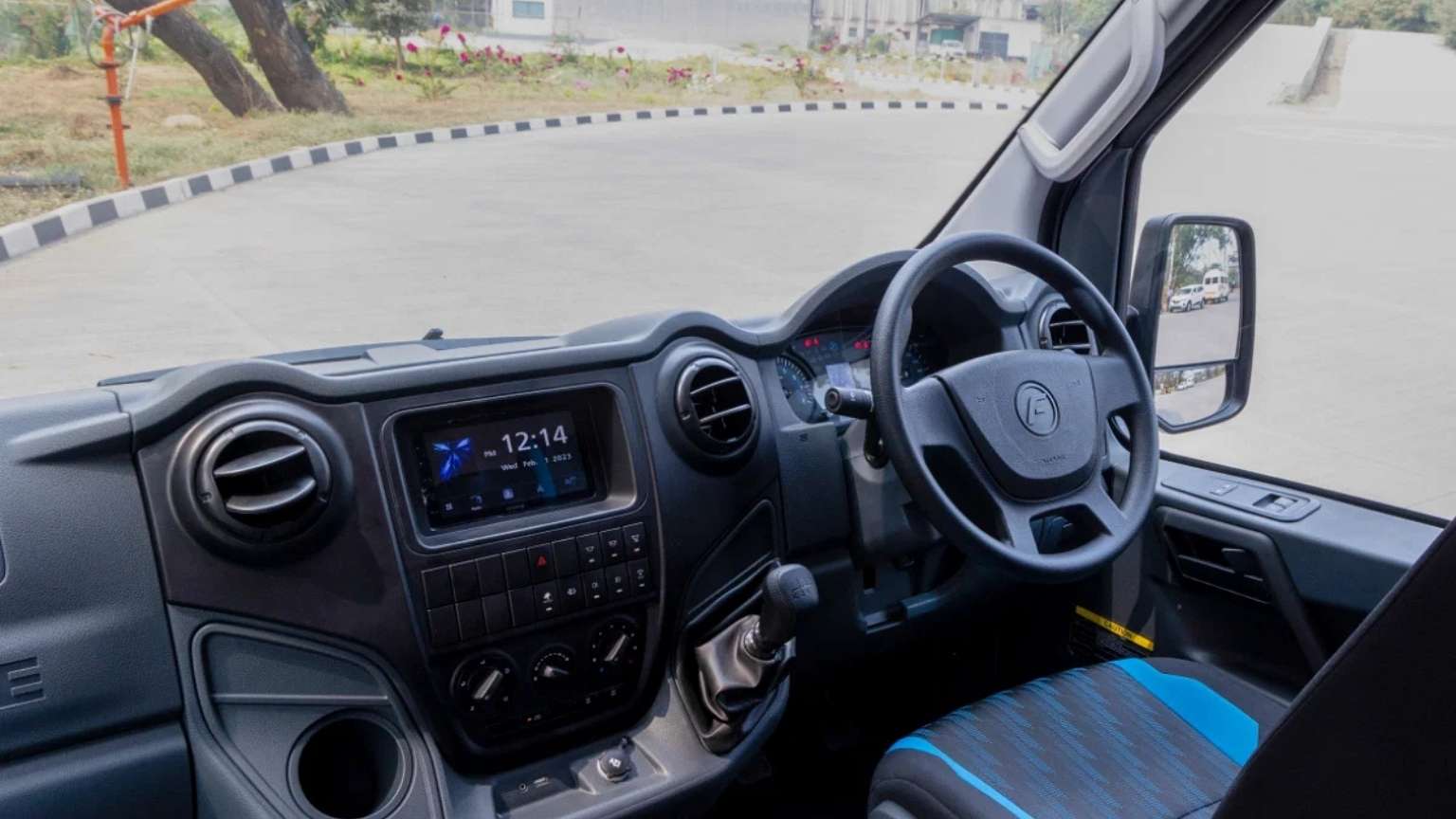 The Force Urbania van's dashboard and steering wheel, featuring modern designs, are shown for Madurai group cab booking purposes.