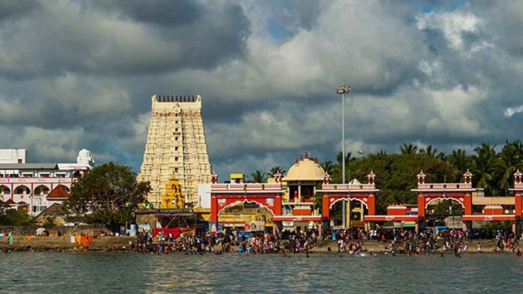 The entrance to the Rameswaram temple and its tower, with pilgrims on the beach, is a great sight for those traveling from Madurai to Rameswaram.