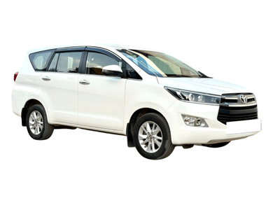 Got a white Toyota Innova Crysta 7-seater cab waiting near the building. It's ready for family and group bookings in Madurai.